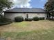 The backyard has a brick exterior with manicured bushes at 6409 Caledon Ct, Locust Grove, GA 30248