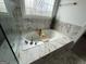 Beautiful bathroom showcasing a soaking tub, marble details, and a glass shower at 6409 Caledon Ct, Locust Grove, GA 30248