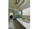 Luxurious bathroom with marble tub, glass shower, and decorative window for natural light at 6409 Caledon Ct, Locust Grove, GA 30248