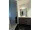 Modern bathroom vanity with double sinks and stylish sliding doors at 6409 Caledon Ct, Locust Grove, GA 30248
