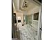 Luxurious bathroom featuring marble flooring, soaking tub, and a glass-enclosed shower at 6409 Caledon Ct, Locust Grove, GA 30248