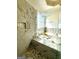 Bright bathroom showcasing a frameless glass shower, a relaxing soaking tub and decorative mosaic tile at 6409 Caledon Ct, Locust Grove, GA 30248