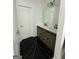 Bathroom featuring a double sink vanity and chic dark marble floors at 6409 Caledon Ct, Locust Grove, GA 30248