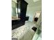 Bathroom with marble flooring, black cabinetry, and a glass enclosed shower at 6409 Caledon Ct, Locust Grove, GA 30248