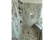 Elegant bathroom featuring a luxurious marble tiled shower with a built-in niche and shower caddy at 6409 Caledon Ct, Locust Grove, GA 30248