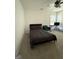 Bright bedroom with neutral carpet, ceiling fan, and large windows at 6409 Caledon Ct, Locust Grove, GA 30248