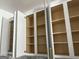 Kitchen cabinet with empty shelves and decorative gold hardware at 6409 Caledon Ct, Locust Grove, GA 30248