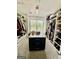 Spacious walk-in closet with custom shelving and a center island for organization at 6409 Caledon Ct, Locust Grove, GA 30248