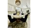 Dining room features a modern chandelier over a round table with stylish velvet chairs at 6409 Caledon Ct, Locust Grove, GA 30248
