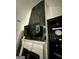 Modern fireplace with striking black marble accent wall and floating television, enhancing the living space at 6409 Caledon Ct, Locust Grove, GA 30248