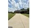 Spacious home boasts a long concrete driveway and lush lawn, creating a welcoming curb appeal at 6409 Caledon Ct, Locust Grove, GA 30248