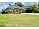 Beautiful brick home features a well-manicured lawn and a spacious driveway leading to an attached two-car garage at 6409 Caledon Ct, Locust Grove, GA 30248