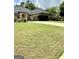 Beautiful brick home features a well-manicured lawn and a spacious driveway leading to an attached two-car garage at 6409 Caledon Ct, Locust Grove, GA 30248