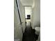 Hallway with dark marble floors leading into a bedroom with a dark bed at 6409 Caledon Ct, Locust Grove, GA 30248