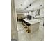 Modern kitchen featuring a large island, pendant lighting, and stainless steel appliances, ideal for cooking at 6409 Caledon Ct, Locust Grove, GA 30248
