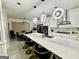 Large kitchen with modern appliances, large island with barstool seating, and stylish lighting at 6409 Caledon Ct, Locust Grove, GA 30248