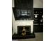 Elegant living room featuring a black marble accent wall with fireplace at 6409 Caledon Ct, Locust Grove, GA 30248