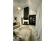 Bright living room featuring a fireplace with black marble design and a large built-in shelving unit at 6409 Caledon Ct, Locust Grove, GA 30248