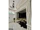 Elegant living room with marble floors, a white couch, and stylish black and gold accents at 6409 Caledon Ct, Locust Grove, GA 30248