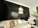 Living room showcasing a decorative black accent wall and a modern white sofa at 6409 Caledon Ct, Locust Grove, GA 30248