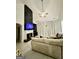 Modern living room showcasing a fireplace with black accent wall and light-colored tile flooring at 6409 Caledon Ct, Locust Grove, GA 30248