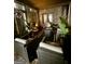 An outdoor patio includes seating, a fire pit table, plants, and brick accents at 6409 Caledon Ct, Locust Grove, GA 30248