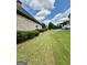 Well-maintained side yard features neatly trimmed shrubs and lush green grass at 6409 Caledon Ct, Locust Grove, GA 30248