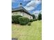 The well-maintained side yard features green grass and a row of bushes at 6409 Caledon Ct, Locust Grove, GA 30248
