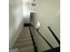 Stylish staircase featuring modern glass railing and neutral carpet at 6409 Caledon Ct, Locust Grove, GA 30248