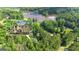 Expansive aerial view of estate, showcasing landscaped grounds, pool, and lake access at 551 Lees Mill Rd, Fayetteville, GA 30214