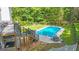 Backyard with a swimming pool, patio seating, and a well-manicured lawn at 551 Lees Mill Rd, Fayetteville, GA 30214