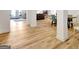 Spacious basement area with wood flooring, white support columns, and visible dining area at 551 Lees Mill Rd, Fayetteville, GA 30214