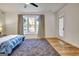 Well-lit bedroom with beautiful wood floors, an exterior door, and a large window at 551 Lees Mill Rd, Fayetteville, GA 30214