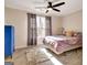 Bright bedroom featuring an oriental style rug, bright accents, and a ceiling fan at 551 Lees Mill Rd, Fayetteville, GA 30214