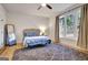 Bright bedroom featuring a large window, a comfortable bed, and a stylish area rug at 551 Lees Mill Rd, Fayetteville, GA 30214