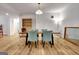 Open dining area featuring wood-look flooring, modern light fixture, and stylish seating at 551 Lees Mill Rd, Fayetteville, GA 30214