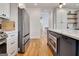Spacious kitchen with stainless steel appliances, an island with a microwave, and hardwood floors at 551 Lees Mill Rd, Fayetteville, GA 30214