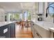 Bright kitchen with white cabinets, stainless steel appliances, hardwood floors, and eat in dining area at 551 Lees Mill Rd, Fayetteville, GA 30214