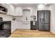 Modern kitchen with white cabinets, stainless steel appliances, and stylish fixtures at 551 Lees Mill Rd, Fayetteville, GA 30214