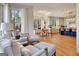 Comfortable living area with hardwood floors and large windows with natural light and kitchen in the background at 551 Lees Mill Rd, Fayetteville, GA 30214