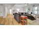 Inviting living room featuring hardwood flooring, a large sofa, and neutral decor at 551 Lees Mill Rd, Fayetteville, GA 30214