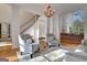 Open-concept living room with hardwood floors, stylish furnishings, and plenty of natural light at 551 Lees Mill Rd, Fayetteville, GA 30214