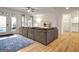 Spacious living room with a large sofa, wood flooring, and access to the outdoor space at 551 Lees Mill Rd, Fayetteville, GA 30214