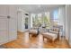 Bright sunroom featuring hardwood floors, oversized windows, and two cozy chairs with ottomans at 551 Lees Mill Rd, Fayetteville, GA 30214
