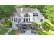 Stunning rear exterior view featuring a deck, a pool, and lush landscaping at 551 Lees Mill Rd, Fayetteville, GA 30214