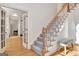 Elegant staircase with carpeted steps and hardwood flooring at 551 Lees Mill Rd, Fayetteville, GA 30214
