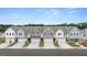 Aerial view of new townhomes, each featuring a two-car garage and modern exteriors at 332 Sinclair Ct # 77, Mcdonough, GA 30253
