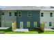 View of the back of the home with a small patio and green grass at 332 Sinclair Ct # 77, Mcdonough, GA 30253
