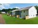 A view of the backyard of several townhomes featuring a green lawn at 332 Sinclair Ct # 77, Mcdonough, GA 30253
