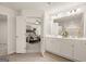 Bright bathroom with double vanity, white cabinets, and a view into the luxurious Primary bedroom at 332 Sinclair Ct # 77, Mcdonough, GA 30253